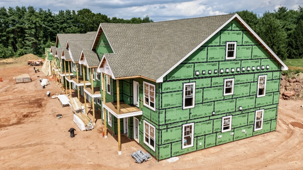 Closer aerial view of apartment construction at 241 Deming Street in South Windsor, Connecticut, showing exterior sheathing, rooflines and site activity.
