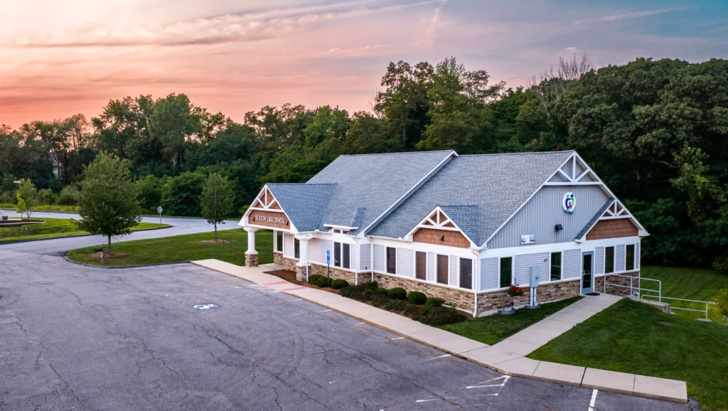 Aerial view of the Bolton Dental office building in Bolton, Connecticut, showing the front entrance, parking area and surrounding trees.