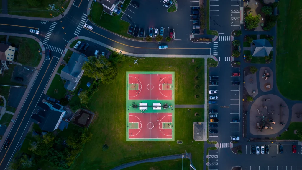 Top-down aerial view of the basketball courts and surrounding park area at Charter Oak Park in Manchester, Connecticut.