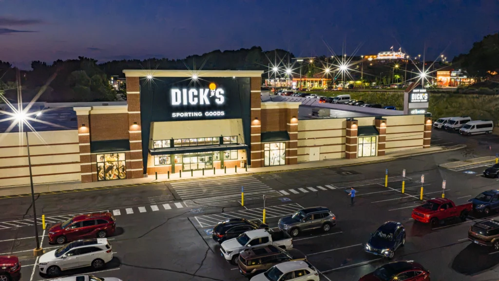 Blue-hour aerial view of the DICK'S Sporting Goods storefront at The Shoppes at Burr Corners in Manchester, Connecticut.
