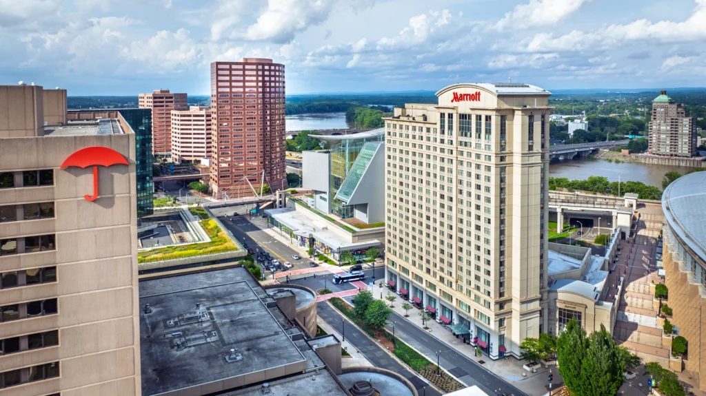 Aerial view of downtown Hartford, Connecticut, featuring the Marriott hotel, Travelers tower and surrounding city buildings.