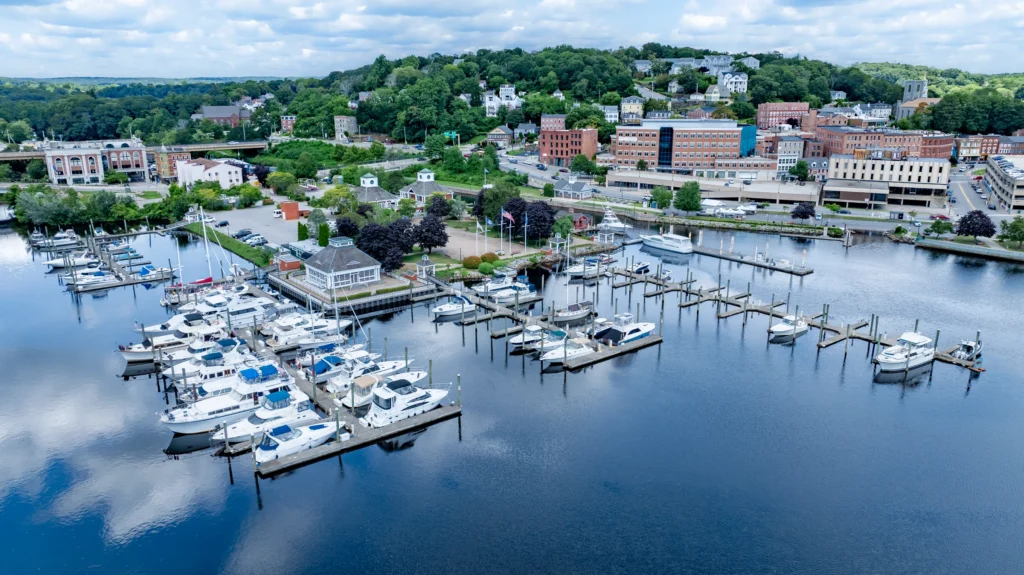 Aerial view of a marina in Norwich, Connecticut, showing docks, boats, slips and the surrounding waterfront.